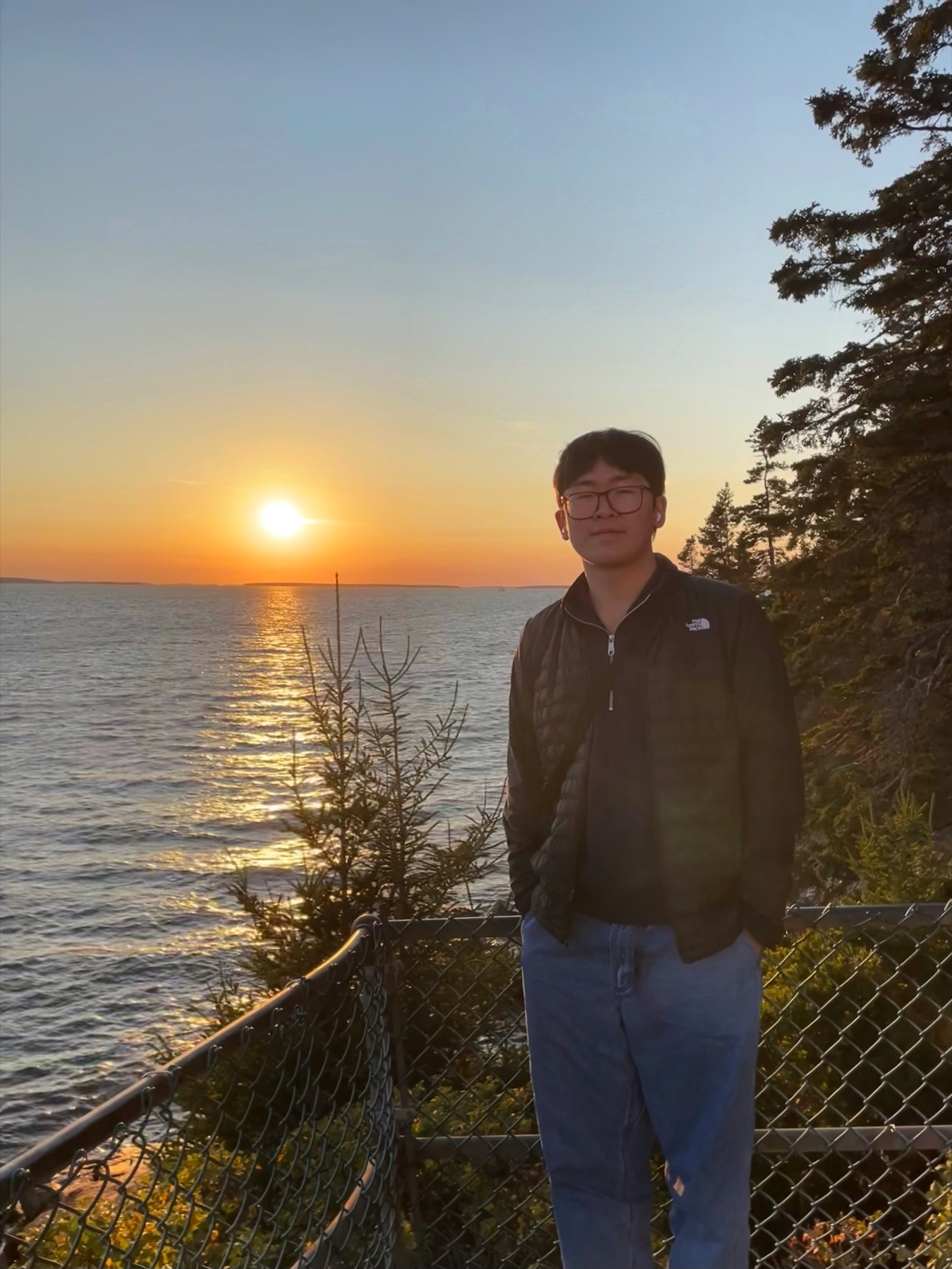 Ethan beside the water at sunset